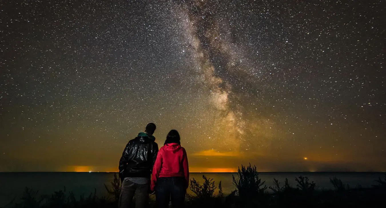Couple under the Milky Way at the beach