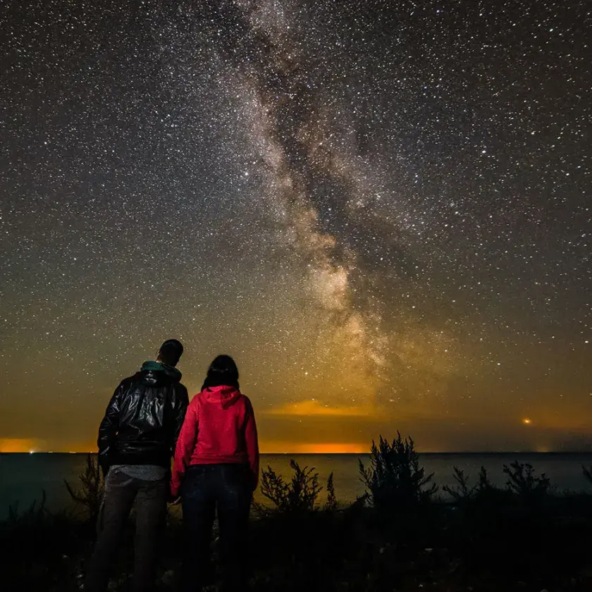 Couple under the Milky Way at the beach
